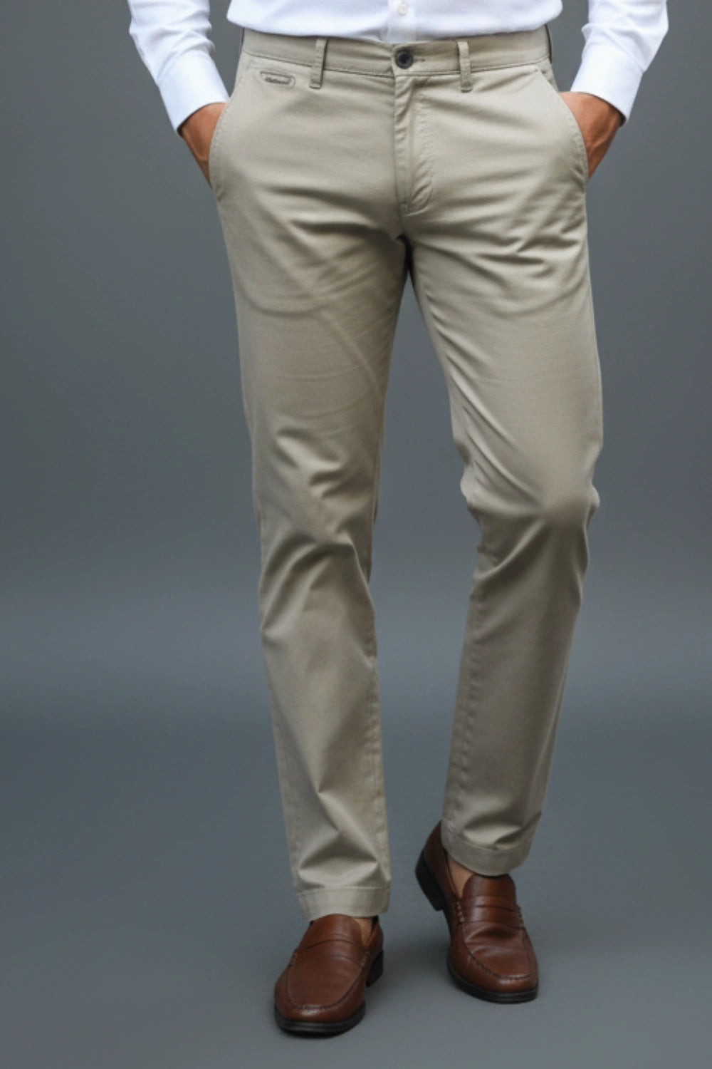 Man wearing light brown cotton pants walking in pose