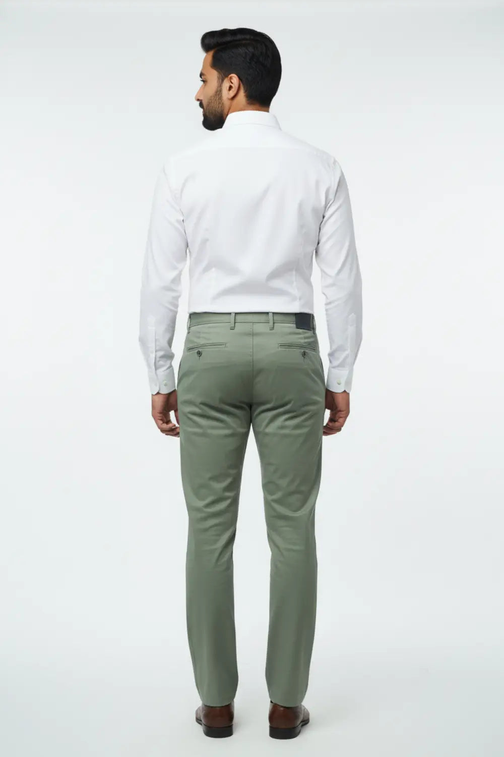 Man wearing a white shirt and olive green pants on a white background