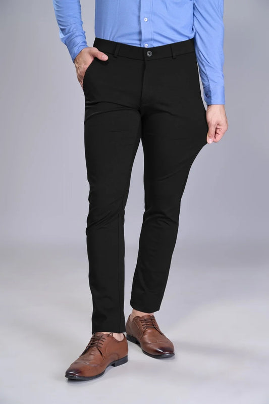 Person wearing black pants and a blue shirt on a gray background