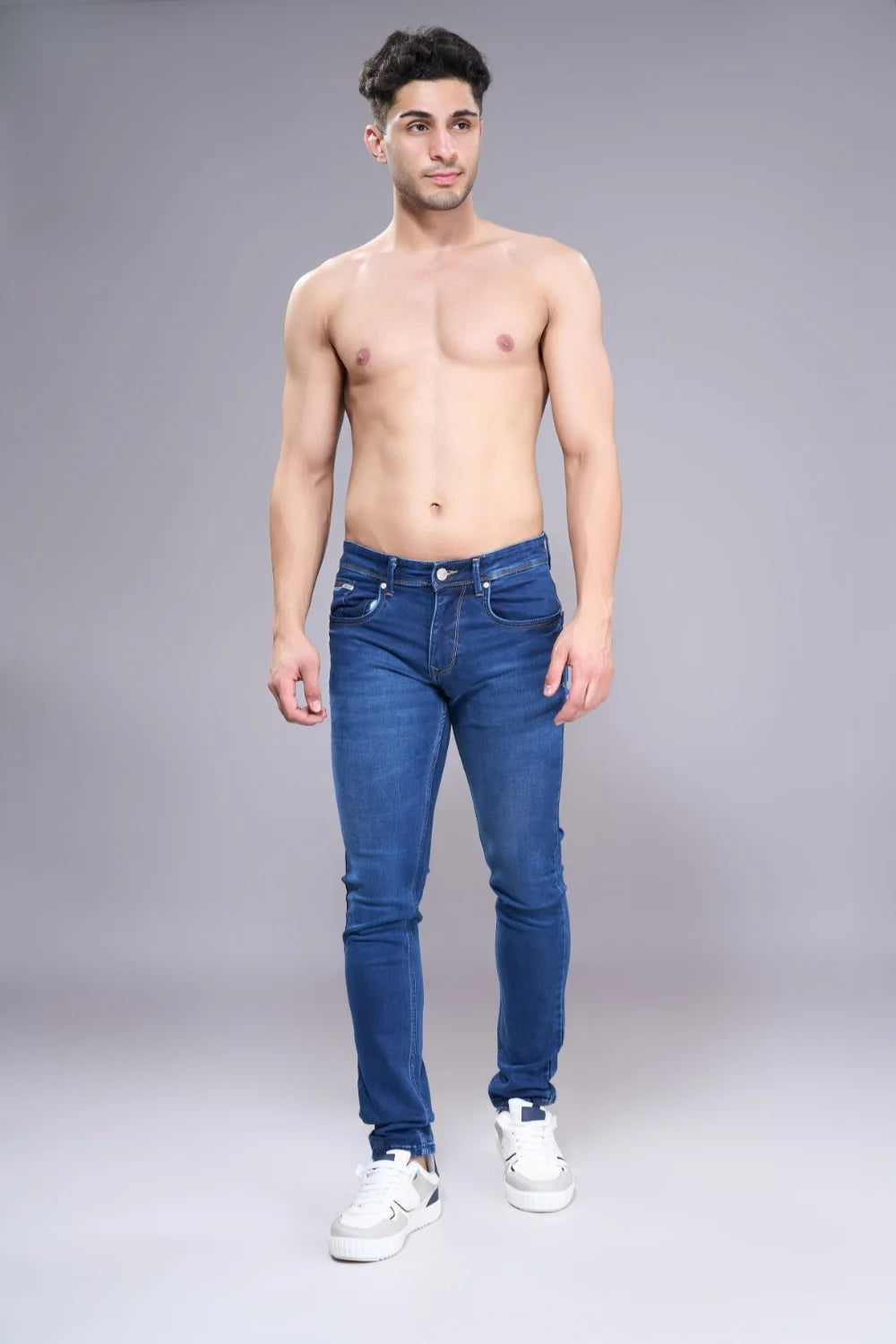 Men’s stretch-supported dark blue denim captured in a relaxed outfit pose
