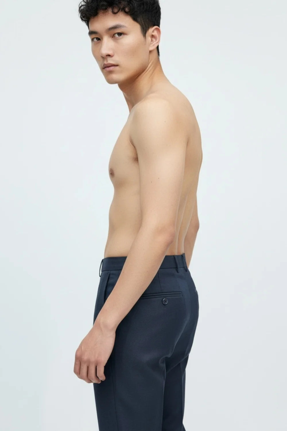 Fabric close-up showing stretch and weave of blue trousers
