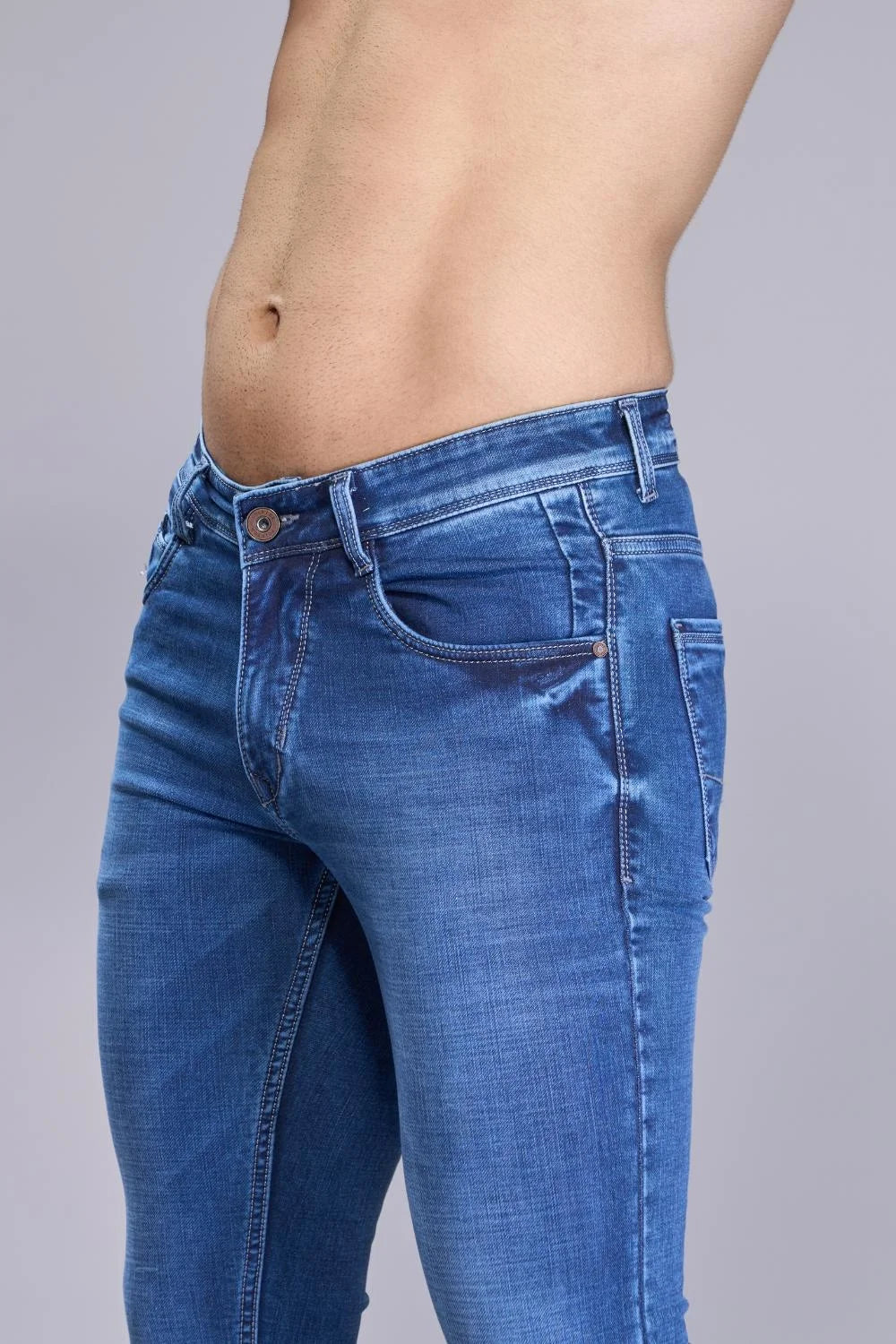 Close-up view of navy blue denim fabric used in men’s jeans
