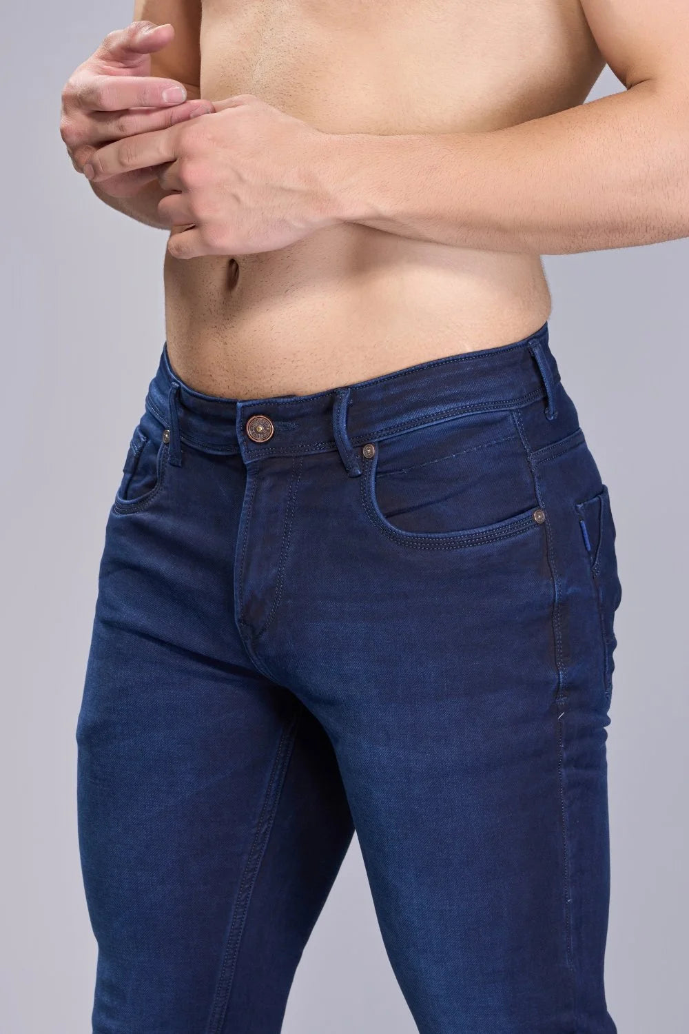 Styled look showing navy denim paired with a belt and minimalist accessories for a polished finish
