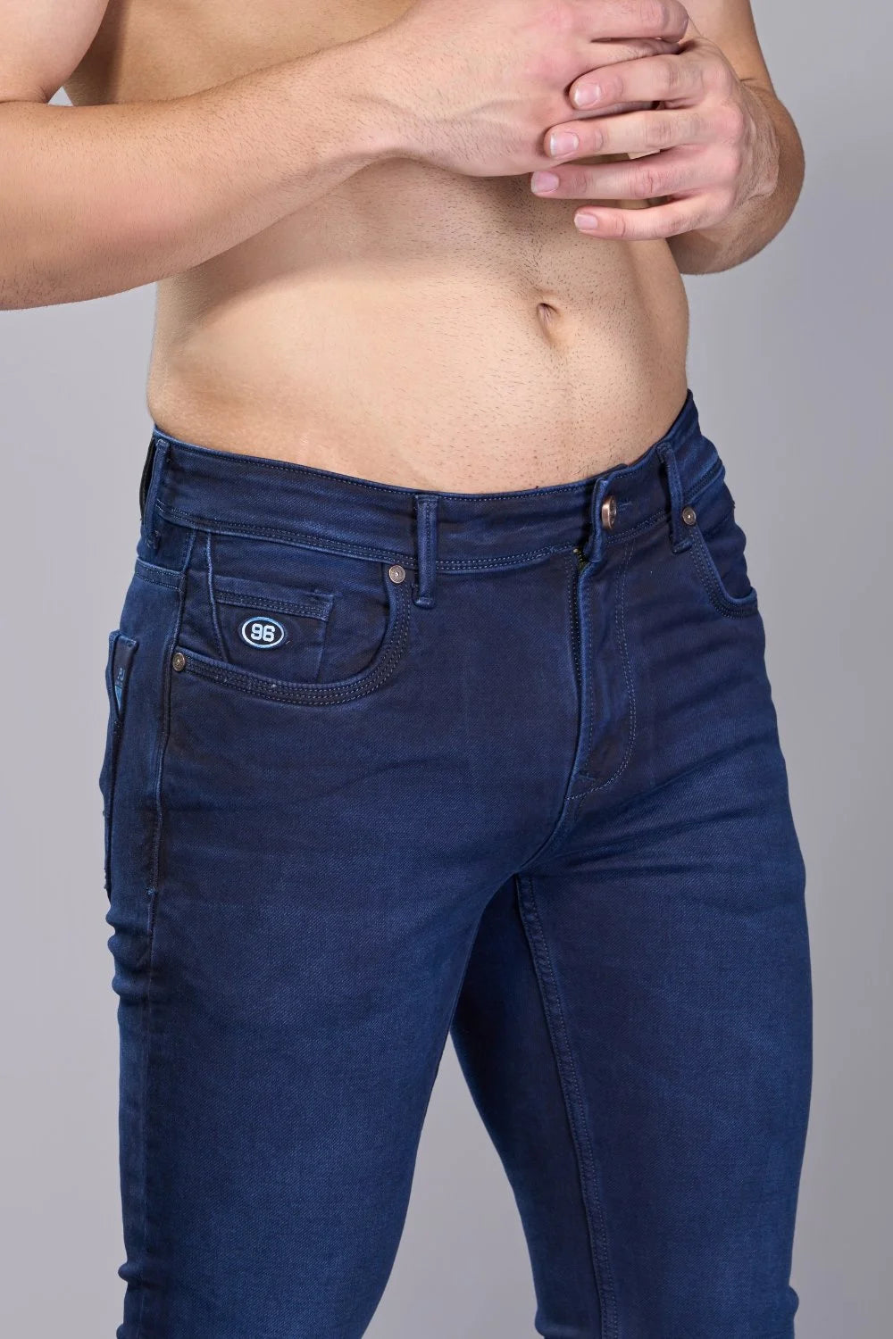 Close view of navy denim grain and subtle tonal wash accents
