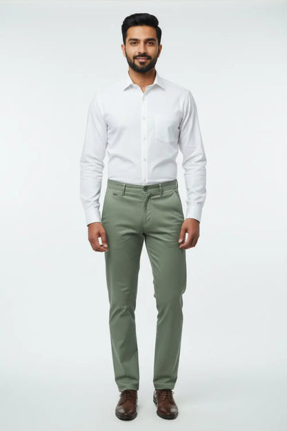 Man wearing a white shirt and green pants on a white background