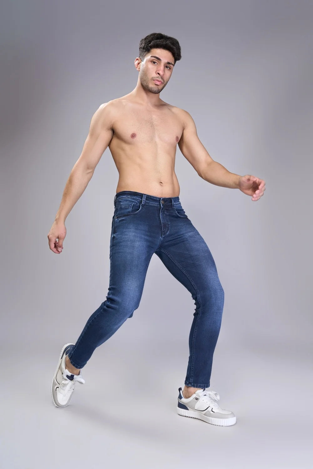 Stretch demonstration of Oxford Blue ankle fit jeans for boys
