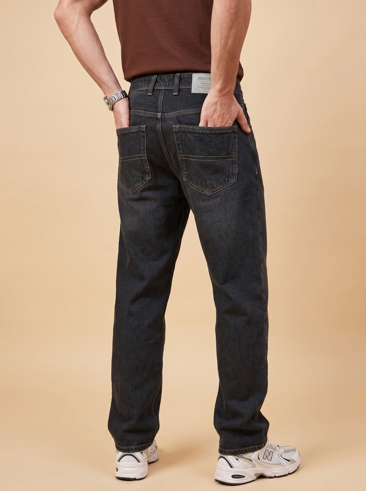 Back view of black loose fit jeans showing rear pockets and relaxed legs