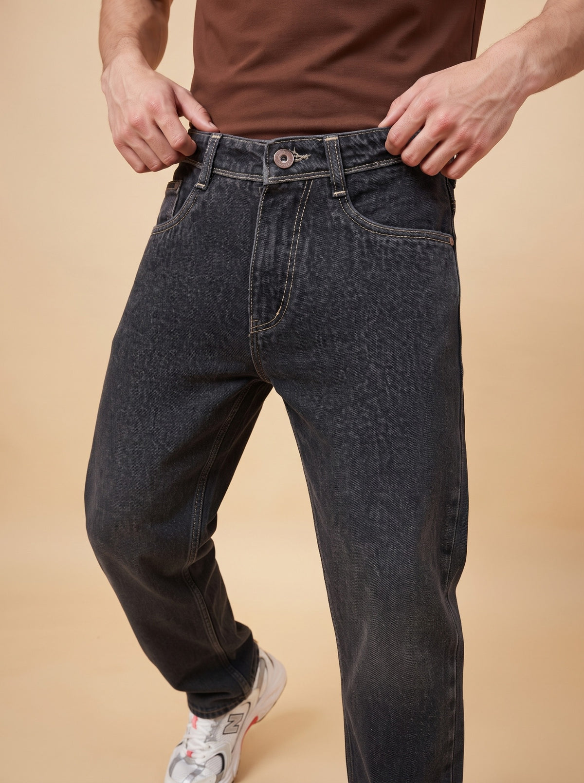 Angled front close-up of black loose fit jeans