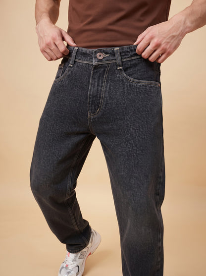 Angled front close-up of black loose fit jeans