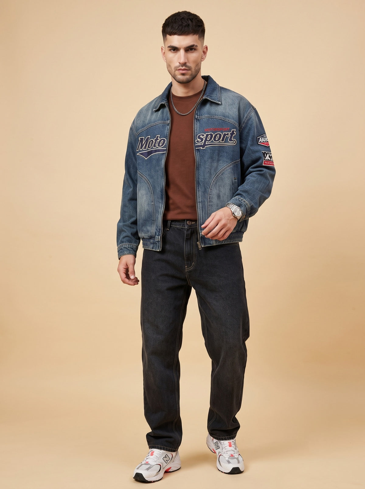 Black loose fit jeans styled with a brown T-shirt, denim jacket and sneakers