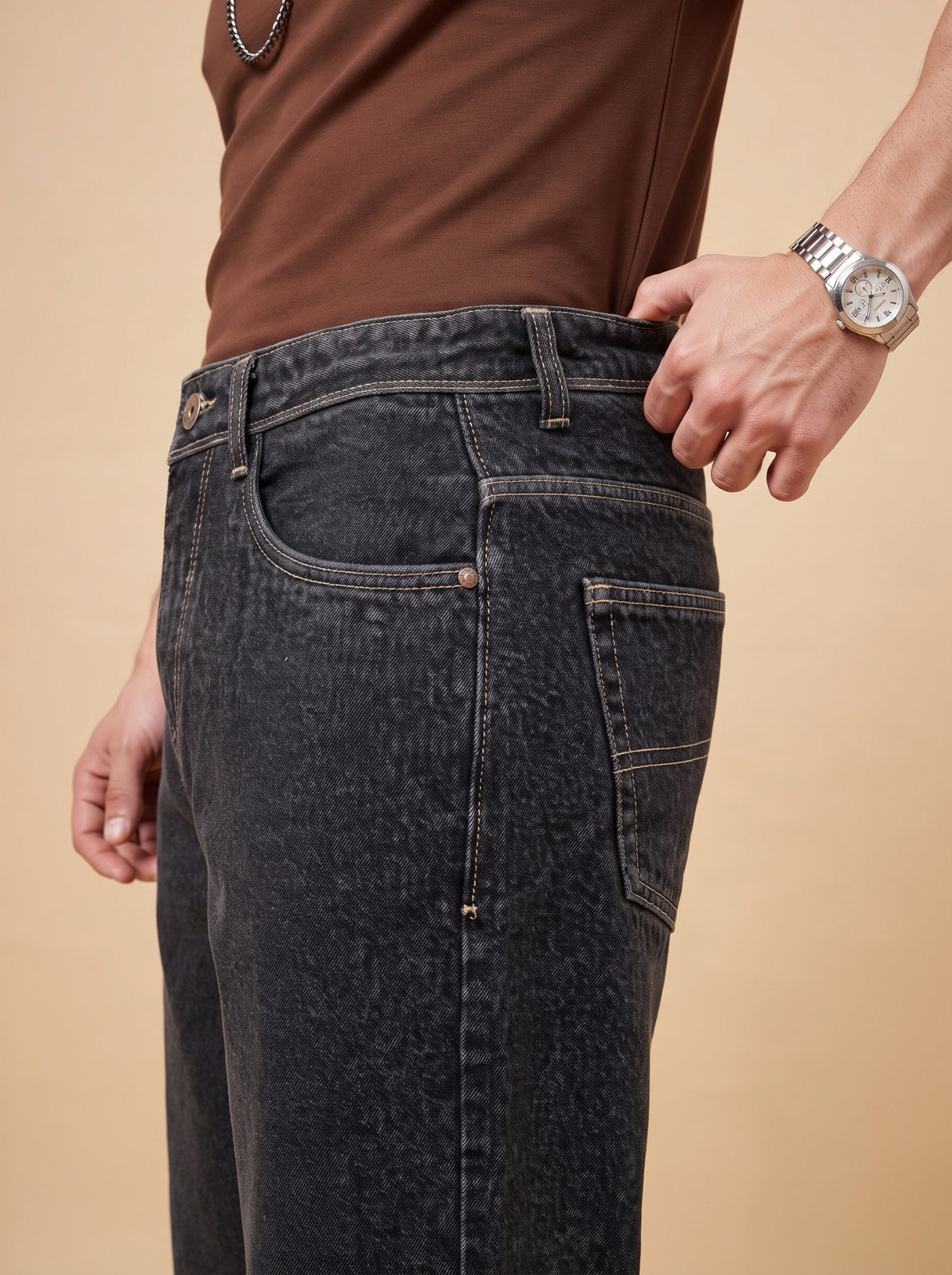 Side seam, front pocket and contrasting stitching on washed black denim