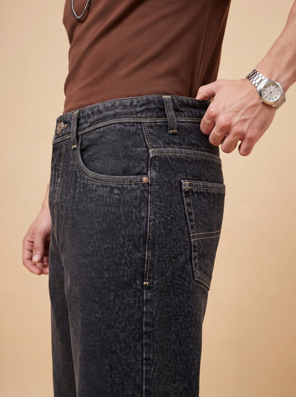 Side seam, front pocket and contrasting stitching on washed black denim