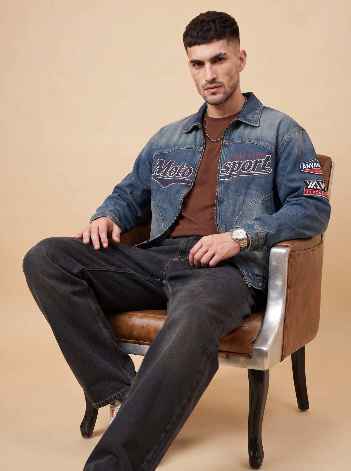 Seated styling view showing the relaxed silhouette of black loose fit jeans