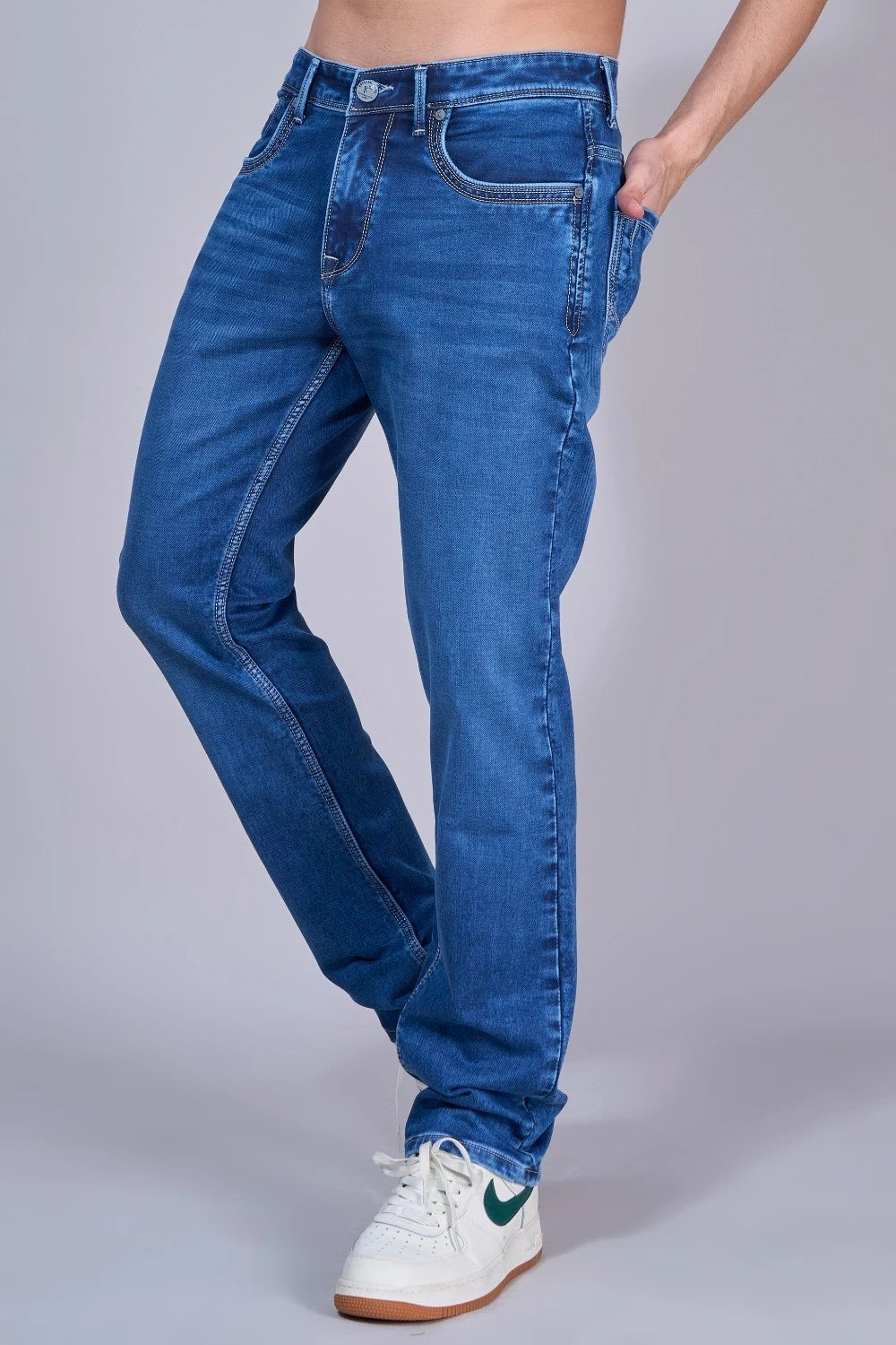 Close-up of stretchable denim fabric in dark blue straight fit jeans