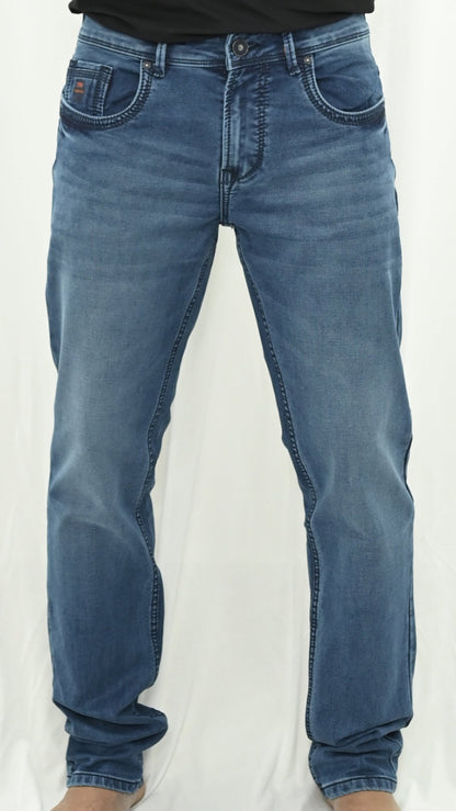 Blue jeans worn by a person on a white background