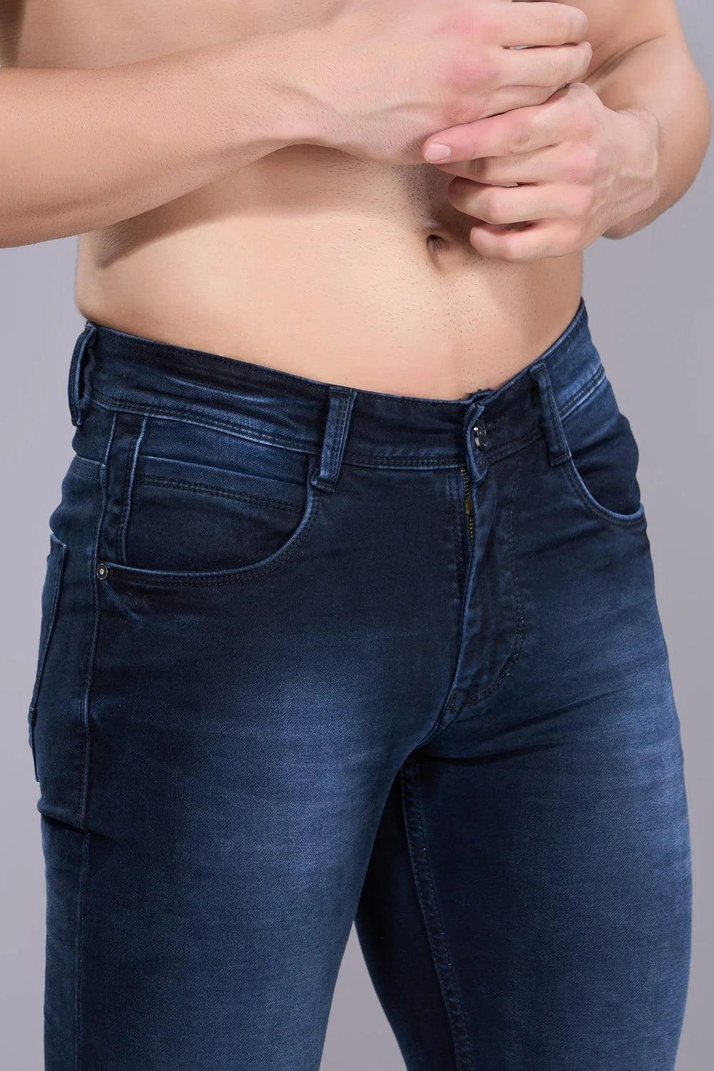 Close-up of premium blue denim fabric used in men's regular fit jeans.
