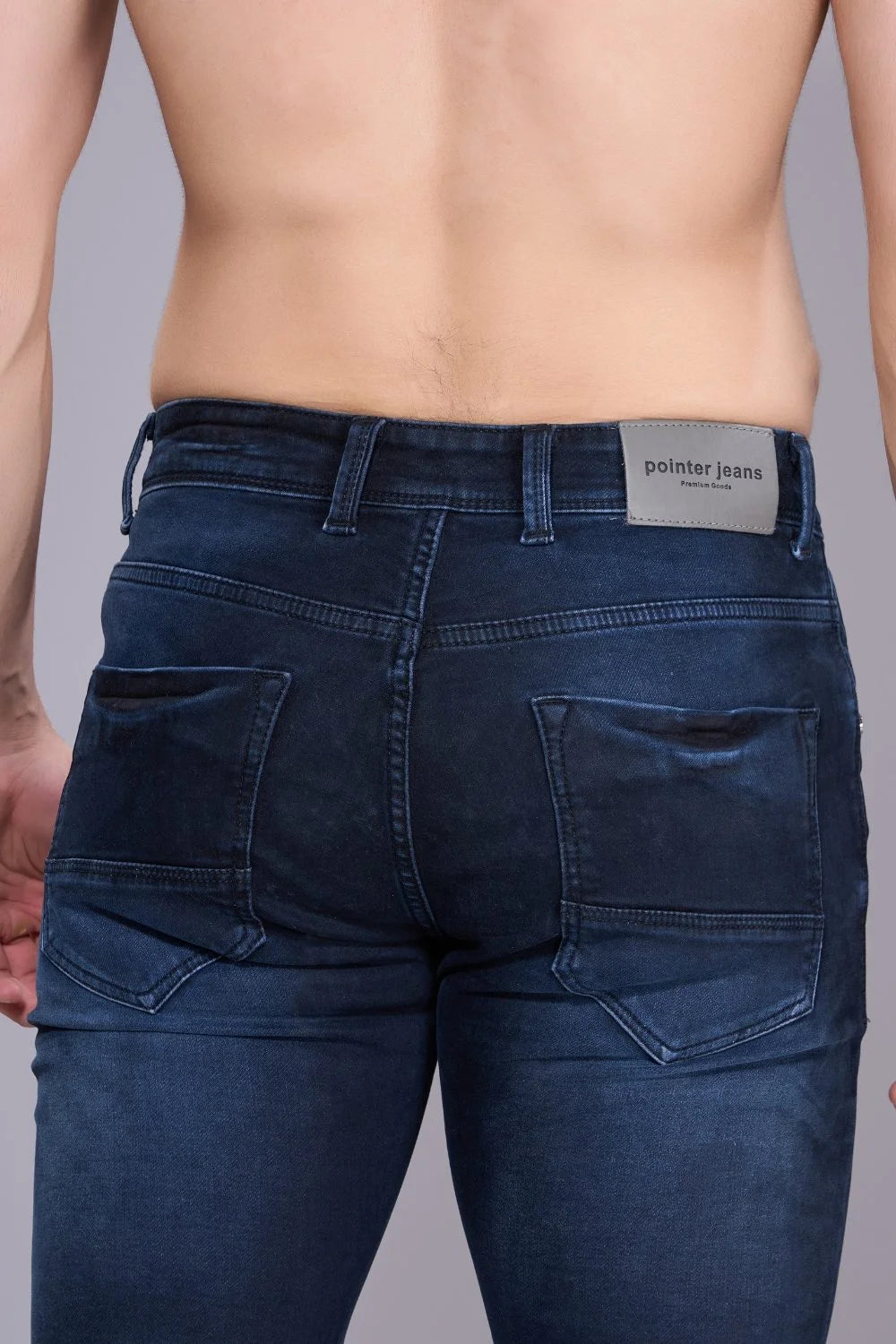 Back view of men’s blue denim regular fit jeans with classic pockets and mid-rise waist.
