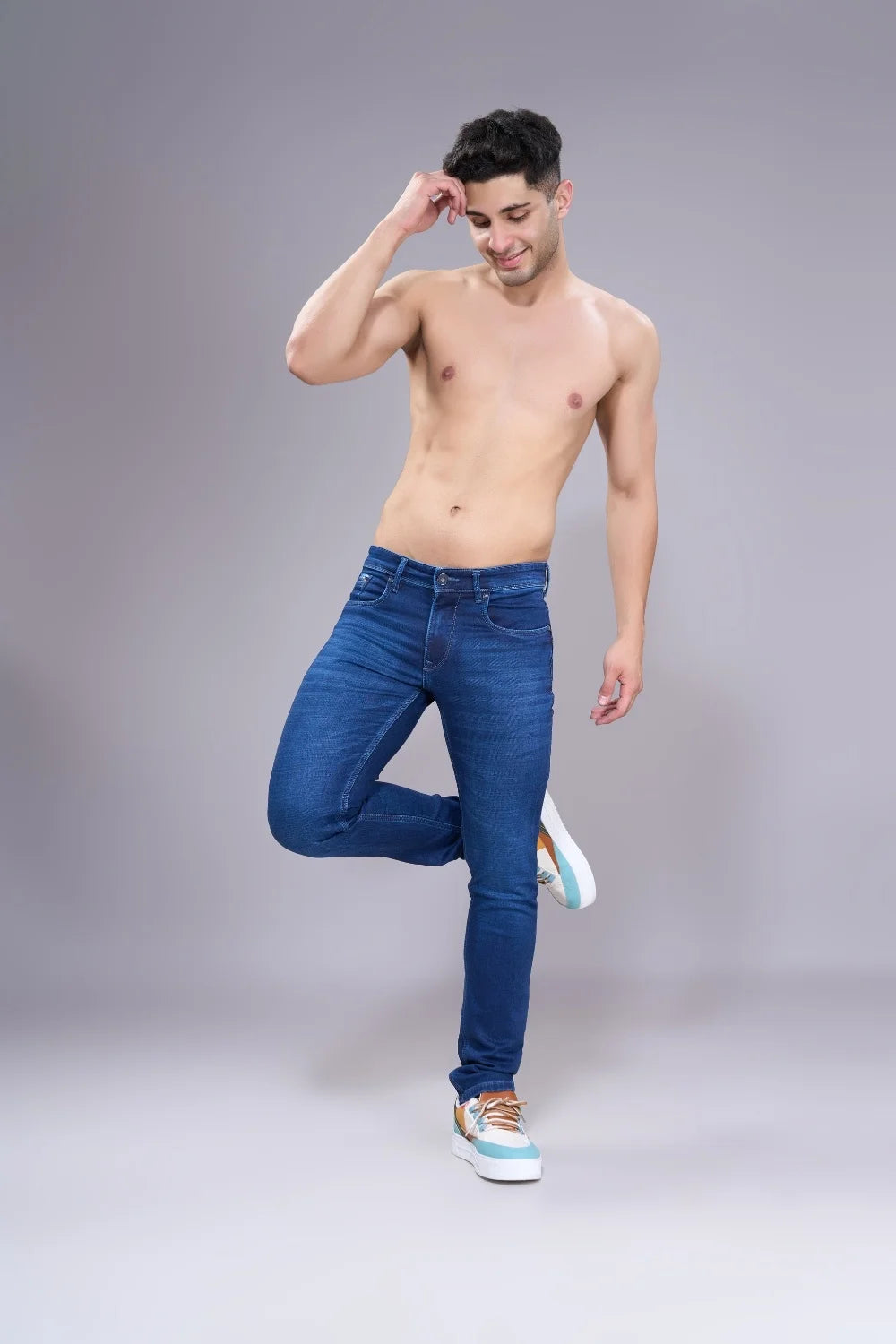 Side angle view of men’s regular fit denim jeans highlighting straight fit

