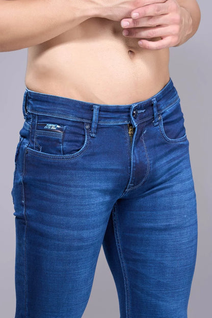 Fabric texture and thigh area close-up of regular fit denim jeans for men
