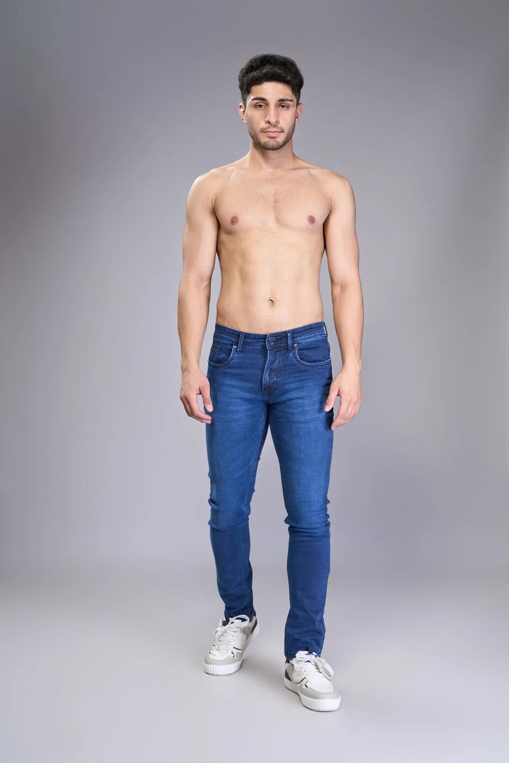 Model wearing men’s regular fit jeans in classic blue denim
