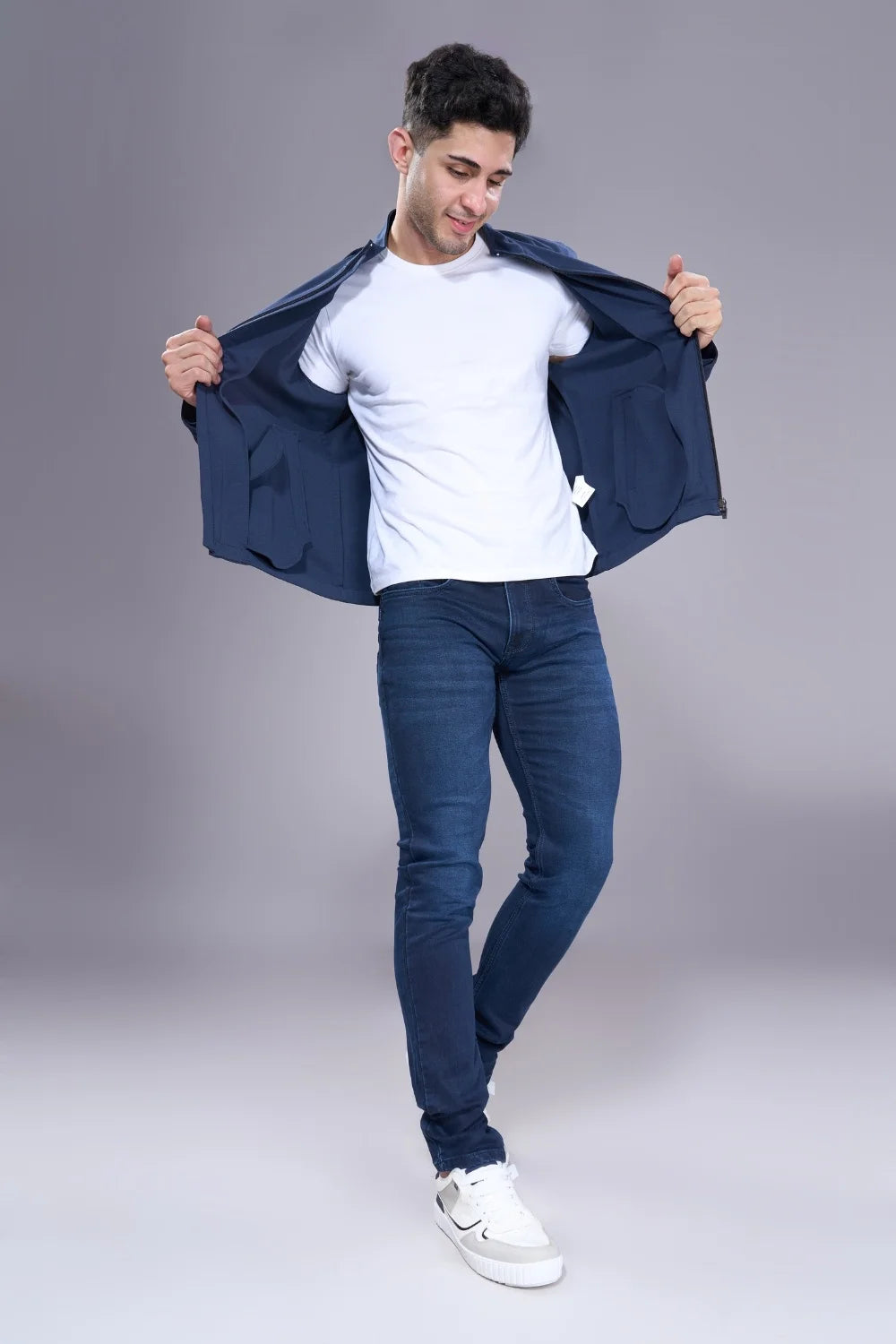 Model wearing regular jeans for men styled with casual outfit
