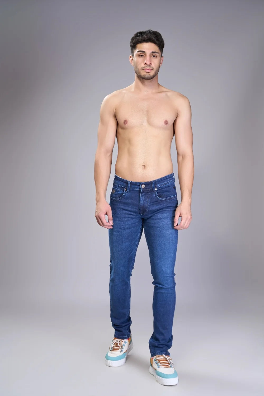 Full body front view of men’s classic regular fit jeans in blue denim
