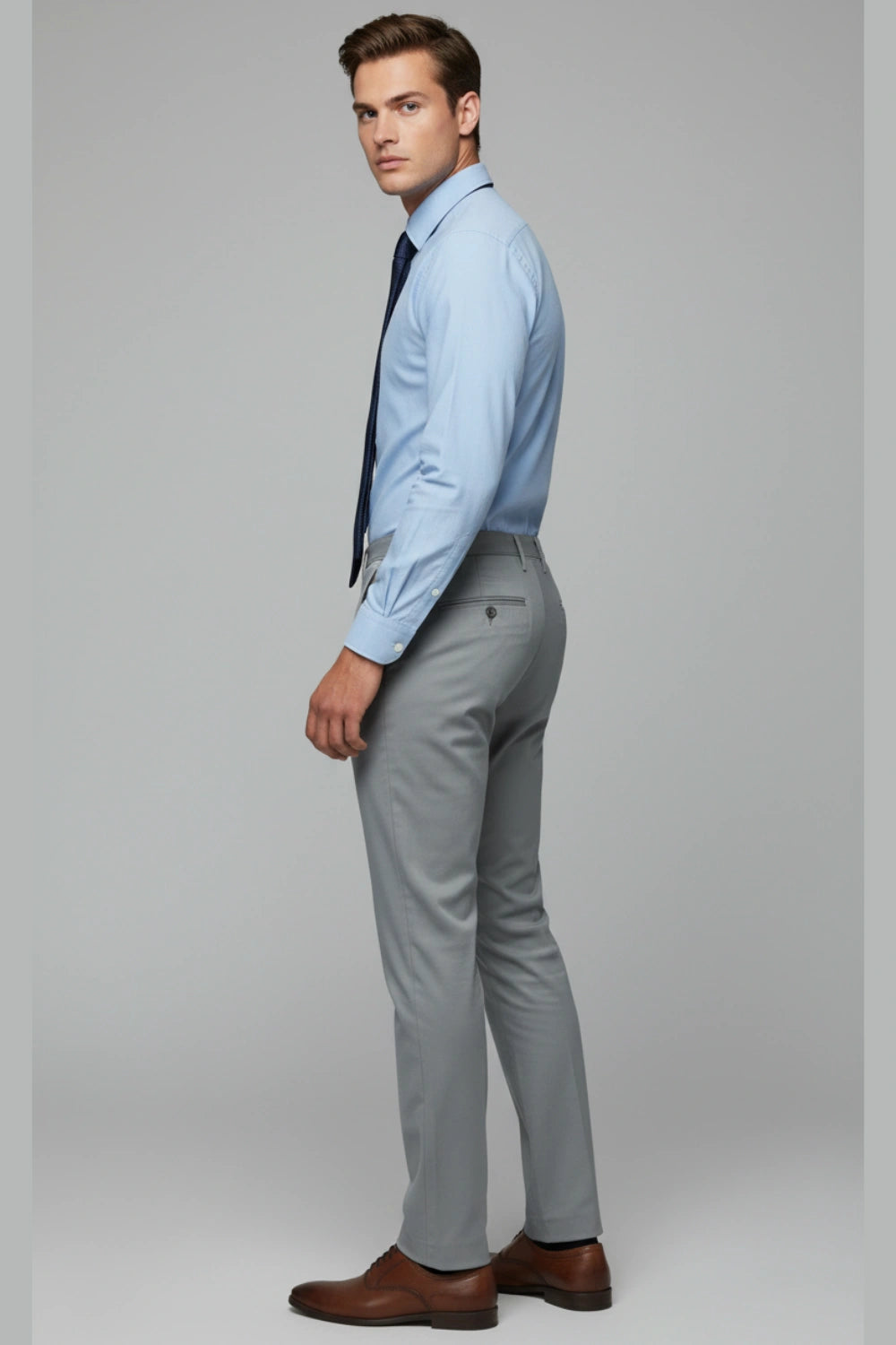 Waist-level shot showing how a leather shoe fits with the dark grey trousers