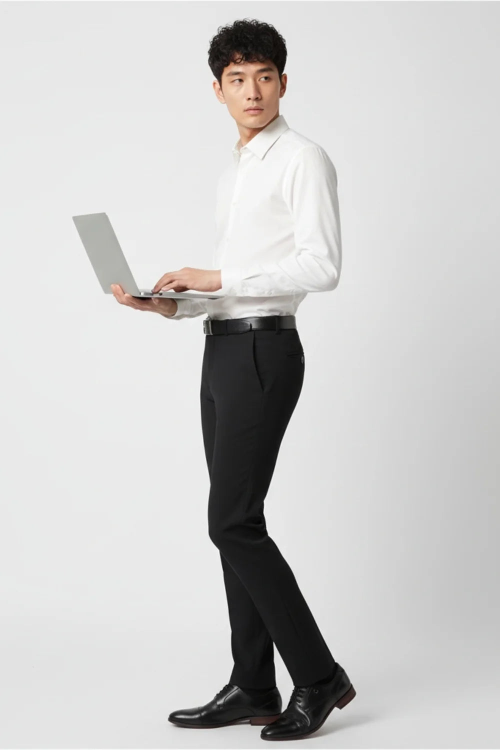 Close-up of tailored trousers showing stitching and fabric texture
