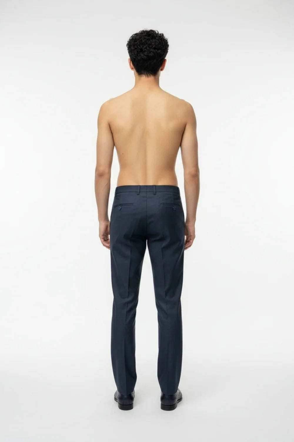 Hem and pocket finishing detail on modern blue formal trousers
