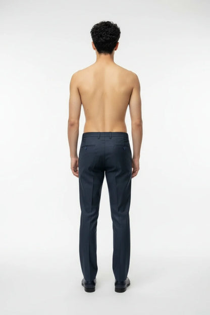 Hem and pocket finishing detail on modern blue formal trousers
