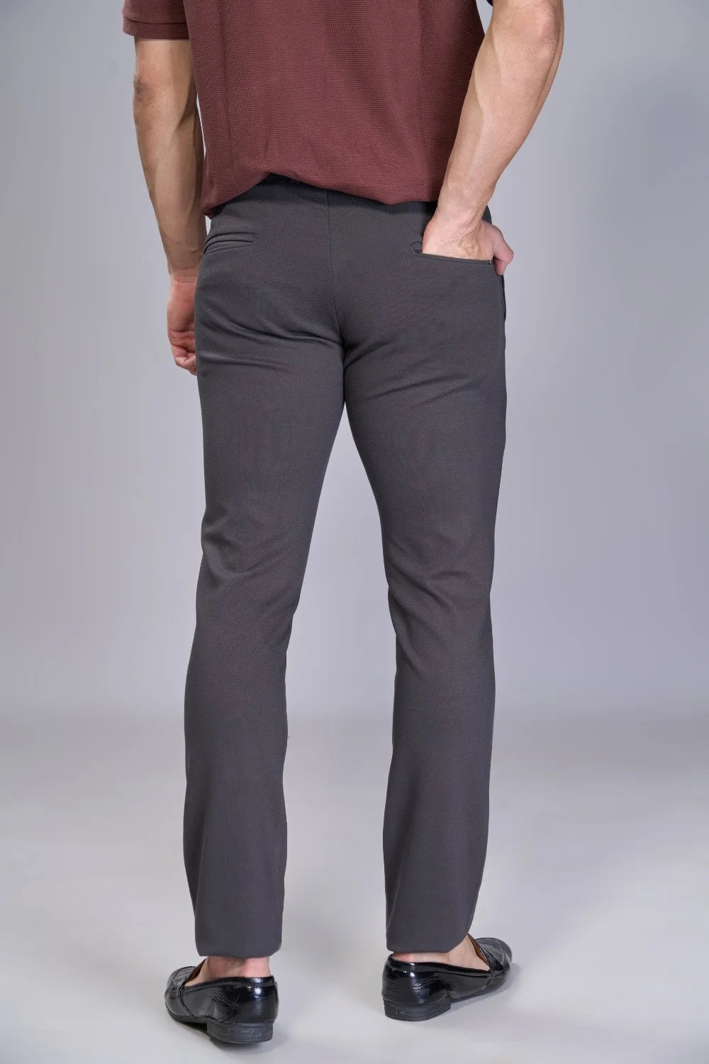 Travel-ready flexible pants in deep grey for commuting and flights
