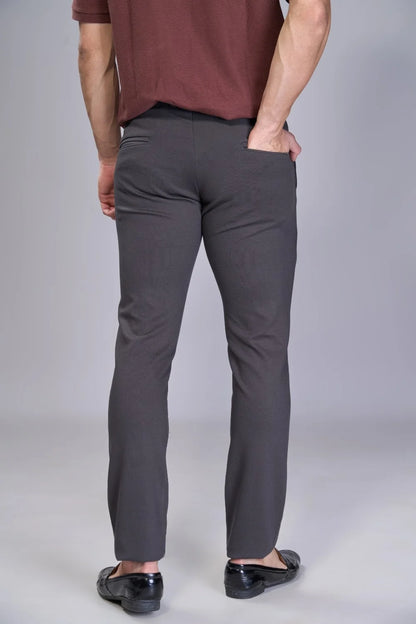 Travel-ready flexible pants in deep grey for commuting and flights
