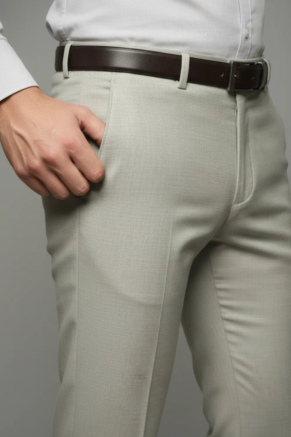 Light White pants with a brown belt on a plain background